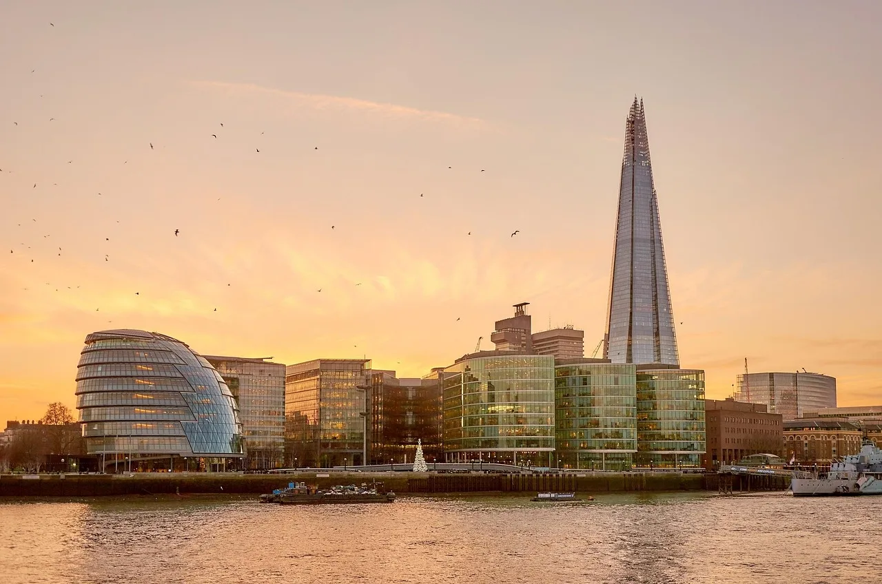 the shard, london, skyline, england, united kingdom, city, kingdom, capital city, building, architecture, landmark, flow, heaven, urban, cities, clouds, tower, famous, river thames, uk, places of interest, skyscraper, tourism, attraction, sightseeing, british, stained glass window, harbor promenade, sunlight, capital, house facade, high, office, facade, ship, glass facade, house front, lighting mood, downtown, tourist attraction, modern art, evening sky, sunset, warship, riverbank, promenade, glass, gulls, evening atmosphere, afterglow, water, dusk, horizon, gold tone, sunny, waves, atmospheric, sun, eve, mood, soft light, sunbeams, reflections, modern skyscraper, discs, silhouette, glittering, reflection, backlighting, office building, residential house, commercial building, pyramid, boats, house